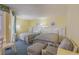 Condo bedroom with two beds and an adjoining sitting area at 2701 South Ocean Blvd. # 710, North Myrtle Beach, SC 29582