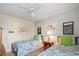 Bedroom with two twin beds, ceiling fan, and beach-themed decor at 194 South Cove Pl. # D, Pawleys Island, SC 29585