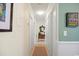 Bright hallway with decorative mirror and access to bedrooms at 194 South Cove Pl. # D, Pawleys Island, SC 29585