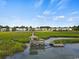 Aerial view of waterfront property with private dock and gazebo, offering serene marsh views at 194 South Cove Pl. # D, Pawleys Island, SC 29585