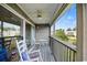 Spacious screened porch with rocking chairs and water views at 194 South Cove Pl. # D, Pawleys Island, SC 29585