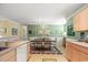 Bright dining area with chandelier and wood table, seating four at 194 South Cove Pl. # D, Pawleys Island, SC 29585