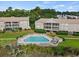 Aerial view of community pool, patio furniture, and nearby buildings at 194 South Cove Pl. # D, Pawleys Island, SC 29585