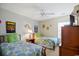 Bedroom with two twin beds, ceiling fan, and beach-themed decor at 194 South Cove Pl. # D, Pawleys Island, SC 29585