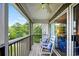 Serene screened porch with rocking chairs and lush landscaping at 194 South Cove Pl. # D, Pawleys Island, SC 29585