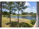 Scenic view of a lake with houses and lush greenery at 583 Starlit Way, Myrtle Beach, SC 29579