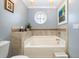 Bathroom with a large tub and round window at 919A N Waccamaw Dr., Murrells Inlet, SC 29576