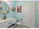 Small bathroom with white vanity and seashell decor at 919A N Waccamaw Dr., Murrells Inlet, SC 29576