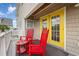 Private balcony with red rocking chairs and yellow door at 919A N Waccamaw Dr., Murrells Inlet, SC 29576