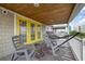 Deck with rocking chairs, hammock, and yellow door at 919A N Waccamaw Dr., Murrells Inlet, SC 29576