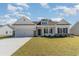 Two story craftsman style home with white siding and brick accents at 58 Millsite Ct., Georgetown, SC 29440