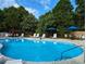 Inviting community pool with ample lounge chairs and umbrellas at 120 A Da Gullah Way # A, Pawleys Island, SC 29585