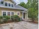 Tan colored home with white trim and a spacious concrete patio at 120 A Da Gullah Way # A, Pawleys Island, SC 29585