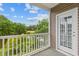 Private balcony overlooking a serene lake and lush trees at 885 Palmetto Trail # 201, Myrtle Beach, SC 29577