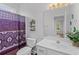 Charming bathroom, featuring a white vanity and purple shower curtain at 885 Palmetto Trail # 201, Myrtle Beach, SC 29577