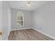 Spacious bedroom with wood-look floors and an arched window at 885 Palmetto Trail # 201, Myrtle Beach, SC 29577