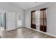 Bright bedroom with wood-look floors and access to a private balcony at 885 Palmetto Trail # 201, Myrtle Beach, SC 29577