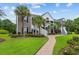 Two-story townhouse with gray siding, white trim, and landscaping at 885 Palmetto Trail # 201, Myrtle Beach, SC 29577