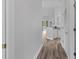 Hallway with light gray walls and wood-look floors at 885 Palmetto Trail # 201, Myrtle Beach, SC 29577