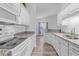 Modern kitchen with white cabinets, granite countertops, and stainless steel appliances at 885 Palmetto Trail # 201, Myrtle Beach, SC 29577