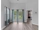 Living room with sliding glass doors leading to a balcony and wooded views at 885 Palmetto Trail # 201, Myrtle Beach, SC 29577