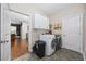 Bright laundry room with washer, dryer, and ample cabinet space at 1225 White Fox Ct., Conway, SC 29526