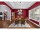 Formal dining room with hardwood floors, red walls, and chandelier at 1225 White Fox Ct., Conway, SC 29526