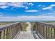 Wooden steps leading to the sandy beach at 2300 N Ocean Blvd. # 238, Myrtle Beach, SC 29577