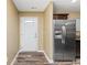 Light and bright entryway with white door and stainless steel refrigerator at 125 S Shore Blvd. # 302, Longs, SC 29568