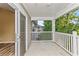 Private balcony with white railings, offering a view of surrounding trees and buildings at 125 S Shore Blvd. # 302, Longs, SC 29568