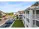 Three-story building with balconies and parking at 125 S Shore Blvd. # 302, Longs, SC 29568