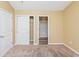 Well-lit bedroom with carpet, double-door closet and en-suite bathroom at 125 S Shore Blvd. # 302, Longs, SC 29568
