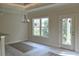 A dining room with large windows and a chandelier at 108 Hallandale Lane, Murrells Inlet, SC 29576