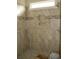 Modern shower with tile surround, built-in shelves, and window at 108 Hallandale Lane, Murrells Inlet, SC 29576