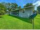 Gray house exterior with a large yard and satellite dish at 312 13Th Ave. S, Surfside Beach, SC 29575