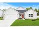 One-story home with gray siding, white trim, and a red door at 7077 Watercress St, Myrtle Beach, SC 29579