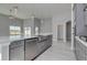 Modern kitchen with gray cabinets, island, and stainless steel appliances at 163 Azure Loop, Myrtle Beach, SC 29588