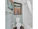 Bright bathroom with toilet, tub, and wood shelving at 1501 S Ocean Blvd. # 1150, Myrtle Beach, SC 29577