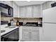 Well-equipped kitchen with white cabinets and appliances at 1501 S Ocean Blvd. # 1150, Myrtle Beach, SC 29577