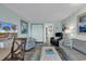Open living area with seating, TV, and access to balcony at 1501 S Ocean Blvd. # 1150, Myrtle Beach, SC 29577