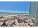 Outdoor patio area with tables, chairs, and ocean view at 2311 Ocean Blvd. S # 361, Myrtle Beach, SC 29577