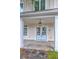 Inviting entryway with light blue double doors, a lantern, and a concrete porch at 10 Saltwater Way, Murrells Inlet, SC 29576