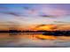 Beautiful sunset reflecting on calm water with a city skyline in the background at 10 Saltwater Way, Murrells Inlet, SC 29576