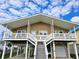 Two-story beach home with front deck and attached garage at 301 61St Ave. N, North Myrtle Beach, SC 29582