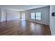 Spacious living room with wood-look floors and large windows at 163 Marsh Deer Place, Surfside Beach, SC 29575