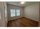 Bright bedroom featuring wood-look floors and two windows at 163 Marsh Deer Place, Surfside Beach, SC 29575