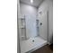 Clean shower with tiled walls and built-in shelving at 163 Marsh Deer Place, Surfside Beach, SC 29575