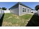 Gray house with small backyard and white fence at 163 Marsh Deer Place, Surfside Beach, SC 29575