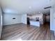 Open living room features wood-look floors and an island kitchen at 163 Marsh Deer Place, Surfside Beach, SC 29575