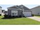 Gray exterior of charming one-story house with white garage door and manicured lawn at 163 Marsh Deer Place, Surfside Beach, SC 29575